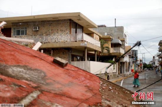 据墨西哥当地媒体报道，受灾最严重的南部瓦哈卡州和震中所在的恰帕斯州有约200多万人受到地震灾害影响。瓦哈卡州州长穆拉特表示，该州因地震遇难的人数已达到71人，其中胡奇坦市已有至少60人身亡。图为胡奇坦市街头，民众从倒塌的房屋废墟前走过。